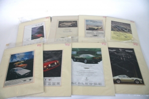 A collection of original mounted Aston Martin adverts