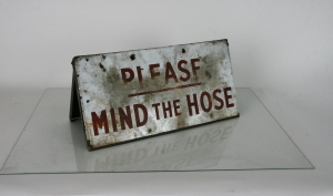 'Mind the hose' metal sign